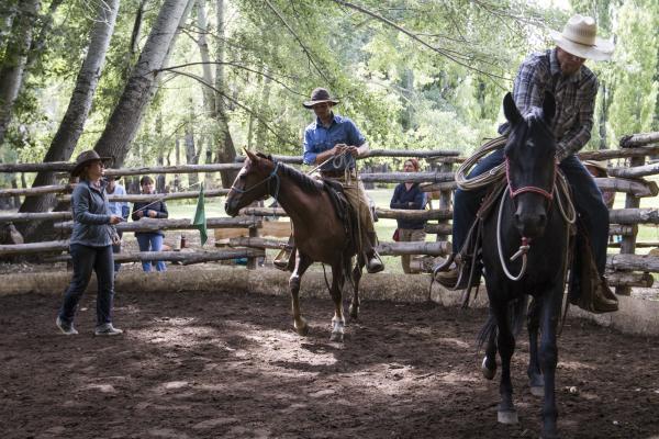 Reata and Gabe Clark in the round corral teaching a natural horsemanship clinic at Estancia Ranquilco