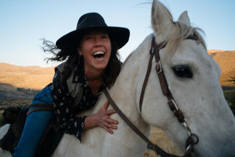 Woman laughing on horseback at Estancia Ranquilco in Patagonia Argentina